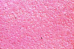 Concrete pink floor with multicolor marble and small natural crushed stones inserted. Pebbles textured background. Decorative rough surface granite. Gravel wall material. Little rock backdrop photo