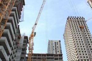 Crane and building construction site. Industry modern new civil house business. Concept of development improvement town. Architecture planning of a city. Renovation project. Residential area photo