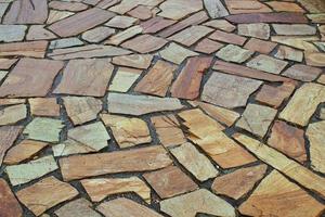 Cobble marble stone paving mosaic texture background. Natural brown slate granite slab mountain rock pebbles wall. Surface seamless tile rough floor abstract backdrop.Architecture element. Close-up photo