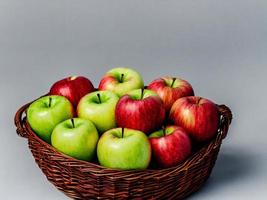 A rustic apple basket overflowing with fresh, juicy apples of different colors and sizes photo