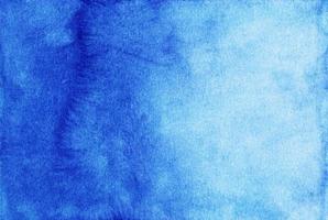 Watercolor deep blue gradient background. Hand painted calm watercolour backdrop. Stains on paper. photo