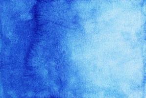 Watercolor deep blue gradient background. Hand painted calm watercolour backdrop. Stains on paper. photo