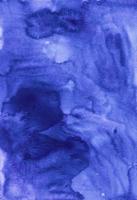 Watercolor deep blue background texture hand painted. Watercolour blue-purple color stains on paper. photo