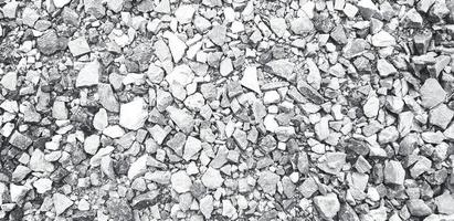 Pattern of small gravel, rock or stone on the ground for background in black and white tone. Hard material, Art or Textured wallpaper and Group of object in monochrome style photo