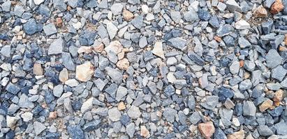 Pattern of small gravel, rock or stone on the floor for background. Hard material, Art or natural wallpaper and Group of object concept photo