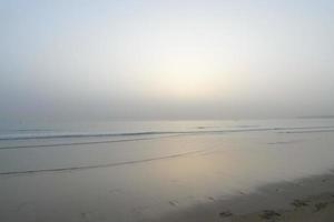 Sun setting over the sea, sunset in autumn on the beach of Zahara de los atunes, Cadiz, Andalucia, Spain photo