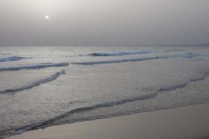 Sun setting over the sea, sunset in autumn on the beach of Zahara de los atunes, Cadiz, Andalucia, Spain photo