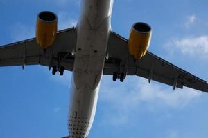 Commercial aircraft overflying the sky and arriving at airport photo