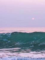 Bubbles on golden beach with ocean water in the morning at Thailand beaches. photo