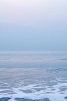 Bubbles on golden beach with ocean water in the morning at Thailand beaches. photo