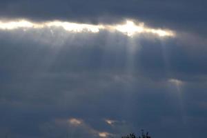 sky between open with rays of sunlight coming through the clouds photo