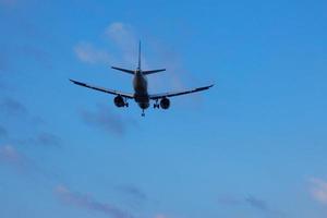 Commercial aircraft overflying the sky and arriving at airport photo