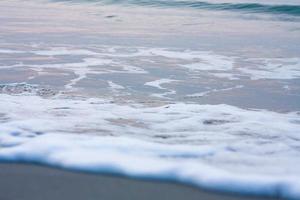 Bubbles on golden beach with ocean water in the morning at Thailand beaches. photo