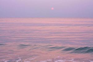 Bubbles on golden beach with ocean water in the morning at Thailand beaches. photo