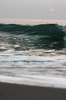 Bubbles on golden beach with ocean water in the morning at Thailand beaches. photo