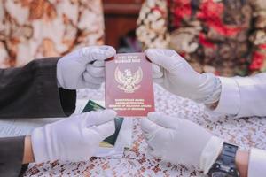 Indonesian marriage book hold with glove photo