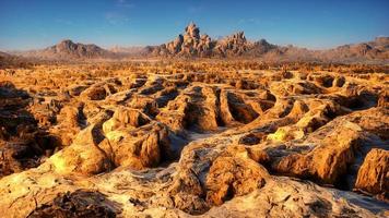 desert with rocks during the day under the light of the sky photo