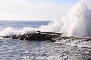 Huge waves crashing on the shore photo