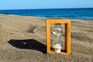 Hourglass on the sand photo