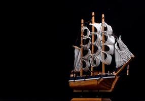 Wooden ship on dark background photo