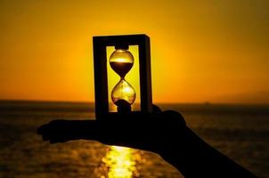 Hourglass and sunset photo