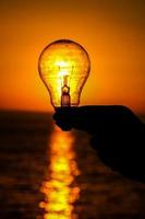 Lightbulb and sunset photo