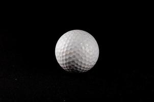 Golf ball on dark background photo