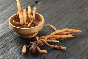 Finger Root on an Black Wooden Table. photo