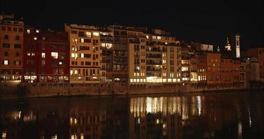 en se av de arno flod i florens på natt, med de känd ponte vechio på de bakgrund video
