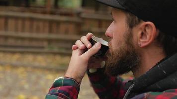 man in a cap with a beard drinks Chinese tea video