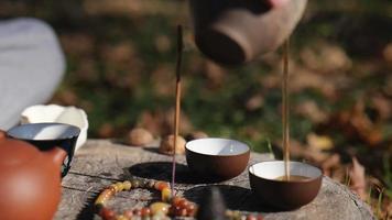 dark pu-erh is poured into tea bowls video
