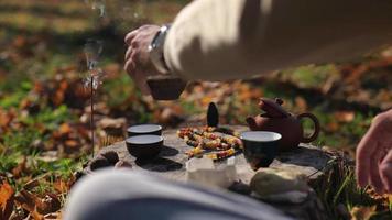 dark pu-erh is poured into tea bowls video