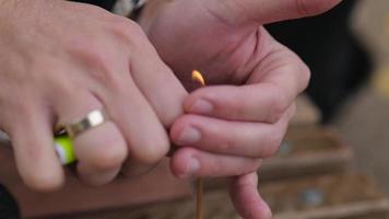 male hands lighting an incense stick video