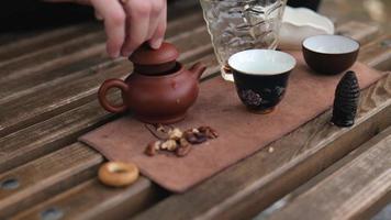 the man closed the lid of the clay teapot and took the teapot in his hand video