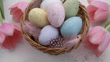 A woman's hand takes a colored Easter egg on the table. video