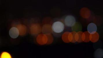 Bokeh in dark blurry background at night, Bokeh of city lights, Defocused night traffic lights, Glassy circular shapes video