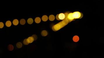 Bokeh in dark blurry background at night, Bokeh of city lights, Defocused night traffic lights, Glassy circular shapes video