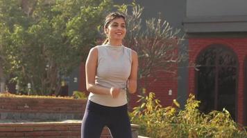 Video of gorgeous fit Indian woman performing cardio exercise.