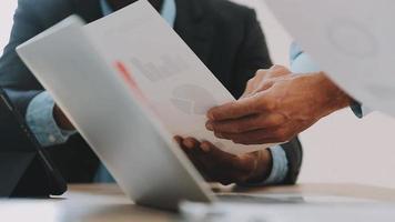 Financial analysts analyze business financial reports on a digital tablet planning investment project during a discussion at a meeting of corporate showing the results of their successful teamwork. video