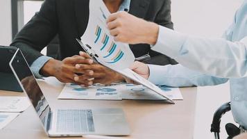 Financial analysts analyze business financial reports on a digital tablet planning investment project during a discussion at a meeting of corporate showing the results of their successful teamwork. video