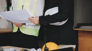 architect man working with laptop and blueprints,engineer inspection in workplace for architectural plan,sketching a construction project ,selective focus,Business concept vintage color video