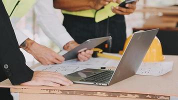 architect man working with laptop and blueprints,engineer inspection in workplace for architectural plan,sketching a construction project ,selective focus,Business concept vintage color video