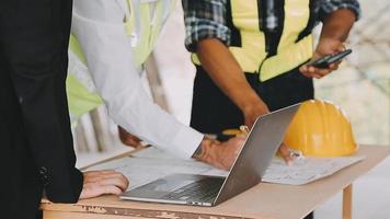 architect man working with laptop and blueprints,engineer inspection in workplace for architectural plan,sketching a construction project ,selective focus,Business concept vintage color video