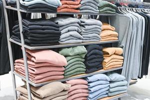 A set of colored sweaters in the store on sale photo