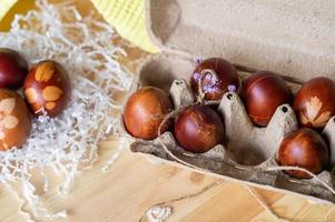 Painted eggs cooked for Easter are in an eco-friendly tray on the table photo