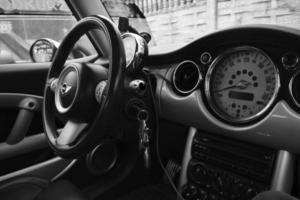 Hand wash with soap, pink foam on the body. Car washing with high pressure water. Wash Mini Cooper. photo