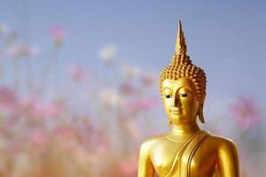 Makha Asanaha Visakha Bucha Day Golden Buddha image. Background of Bodhi leaves with shining light. Soft image and smooth focus style photo