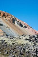 Colorful mountain with a person on top photo