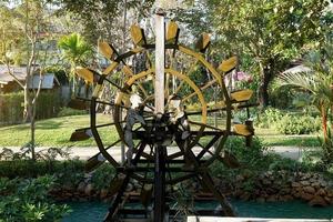 The water baler turbine is used to carry water from low to high. Using the current to spin a large wheel made of wood on the edge of the wheel was a water container. lined up at regular intervals. photo