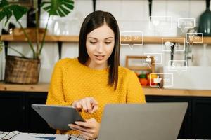 Asian woman typing smartphone, keyboard  with laptop computer of Social media and Marketing virtual icons screen concept. photo